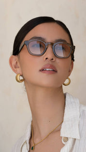 Gray acetate-framed glasses with subtle gradient lenses.