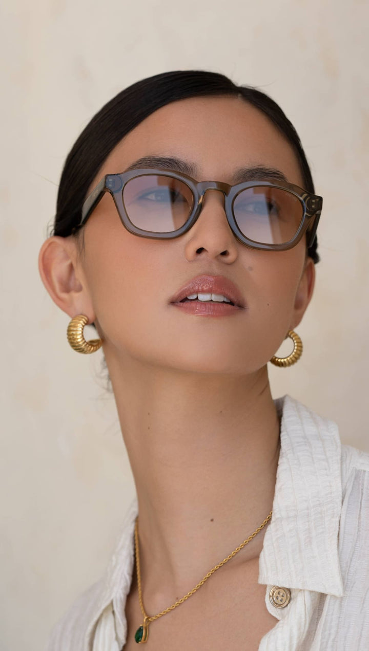 Gray acetate-framed glasses with subtle gradient lenses.
