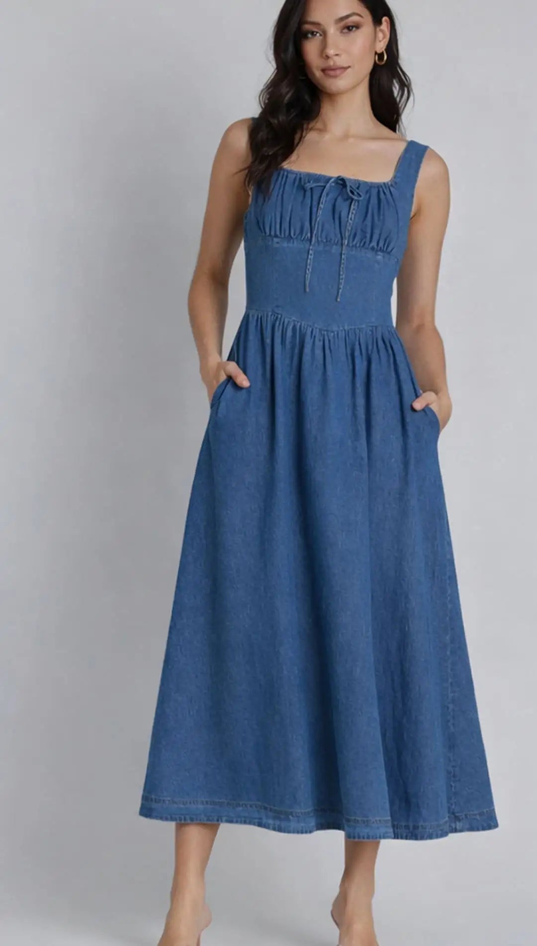 A denim midi dress with a square neckline, gathered bodice and front tie detail.