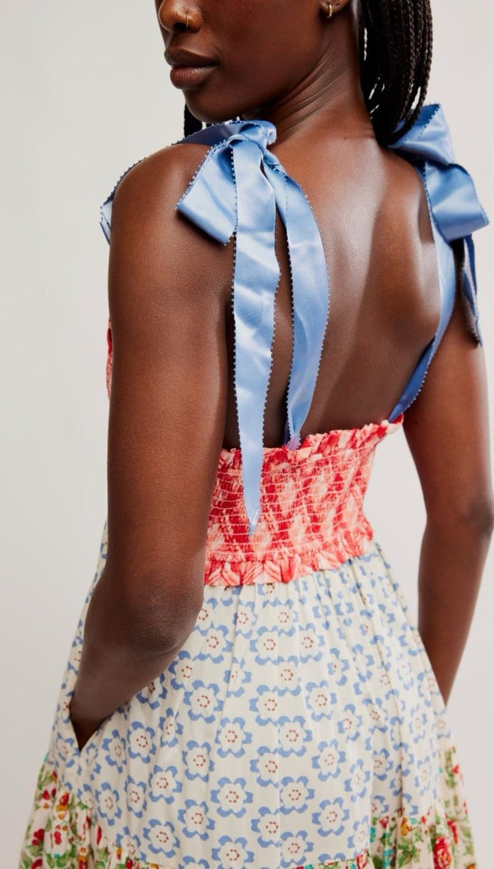 Floral print sundress with blue ribbon straps.