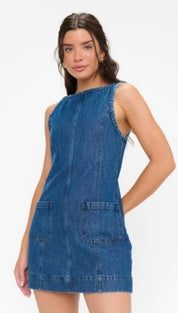A sleeveless denim dress in a medium blue wash with two front patch pockets and a straight hemline.