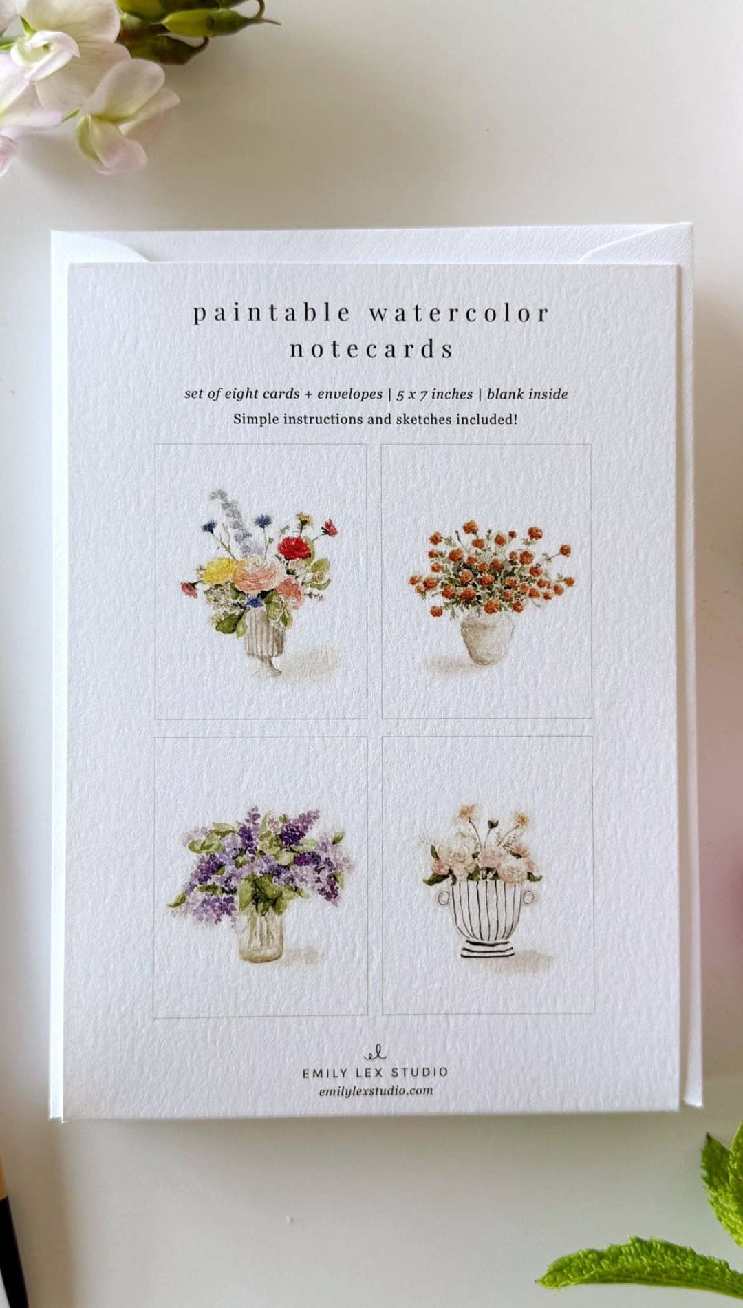 White paintable watercolor notecards with floral designs in pastel hues and gold accents.emily lee studio