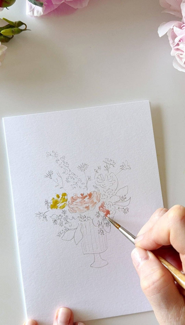 White watercolor paper with floral design and pink flowers