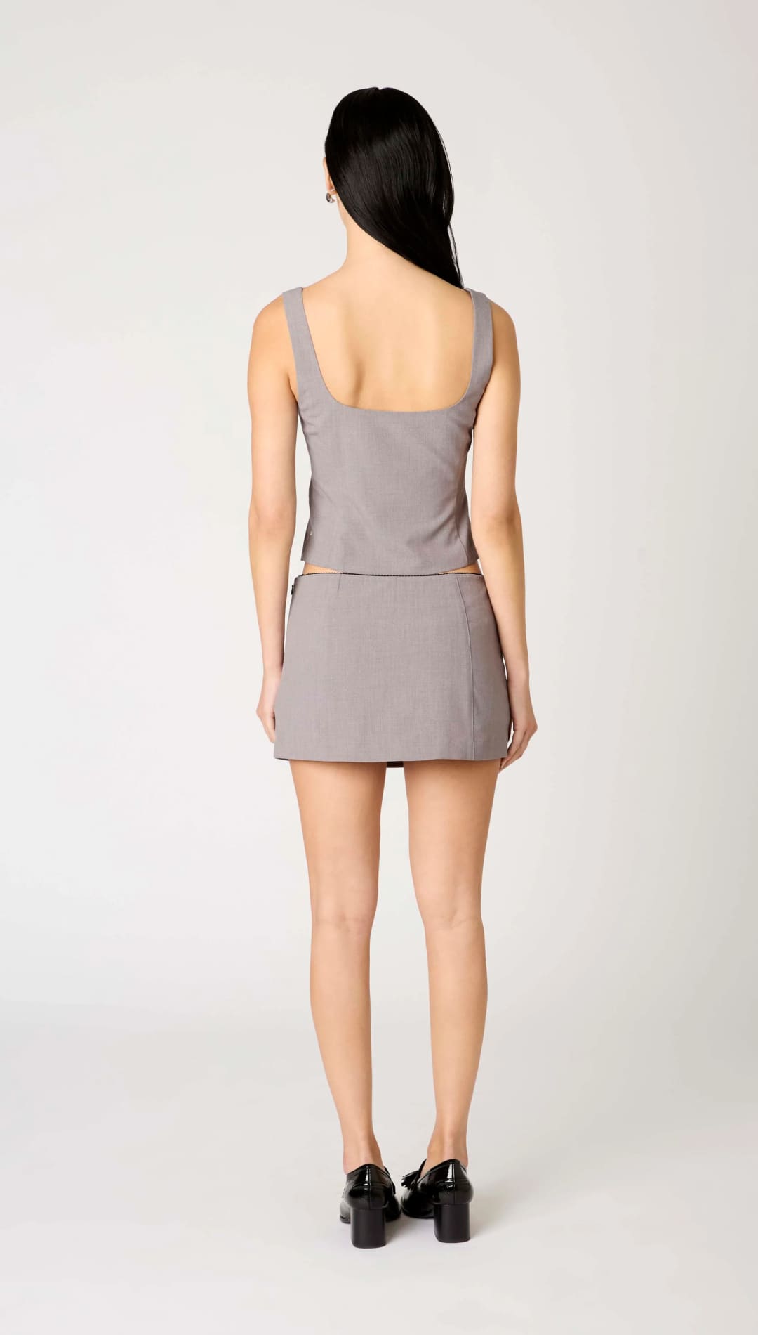 A woman’s sleeveless gray tank top and matching mini skirt.