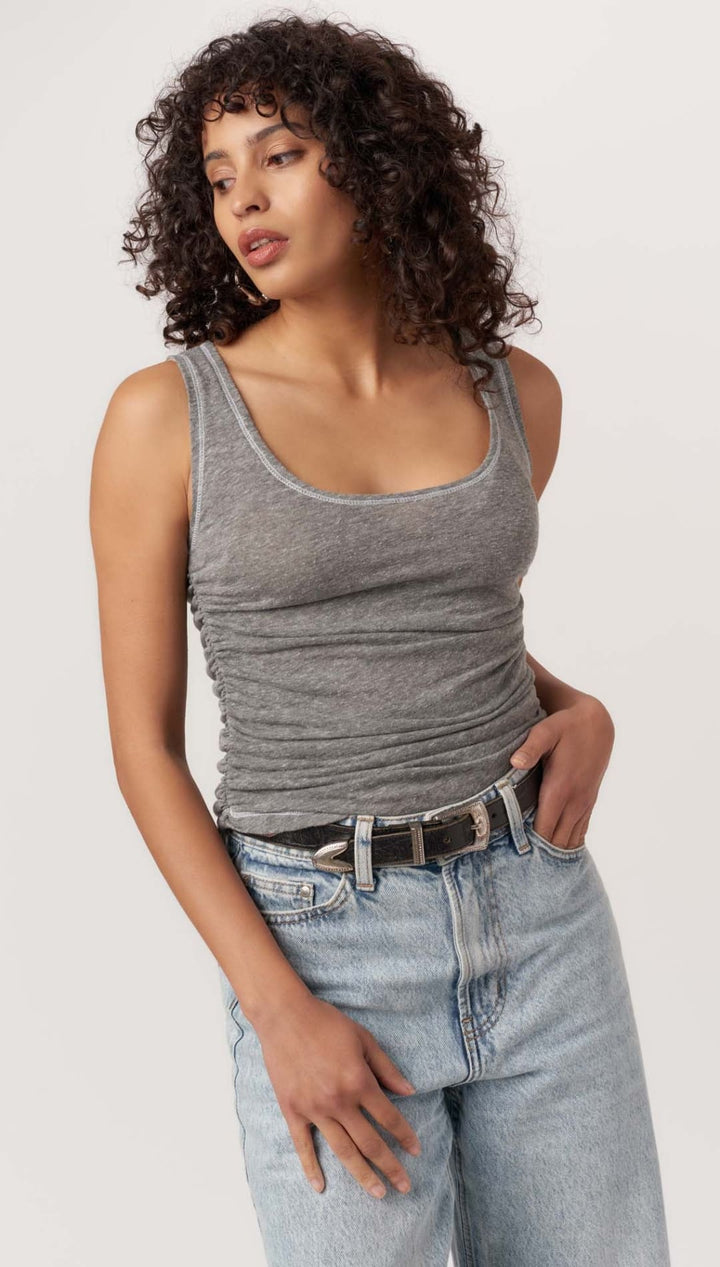 Gray tank top with light-wash jeans.