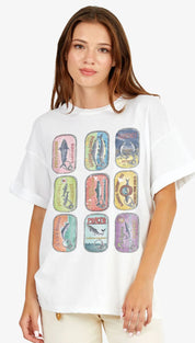 White oversized t-shirt featuring a vibrant, vintage-style graphic of nine colorful canned fish labels arranged in a grid.
