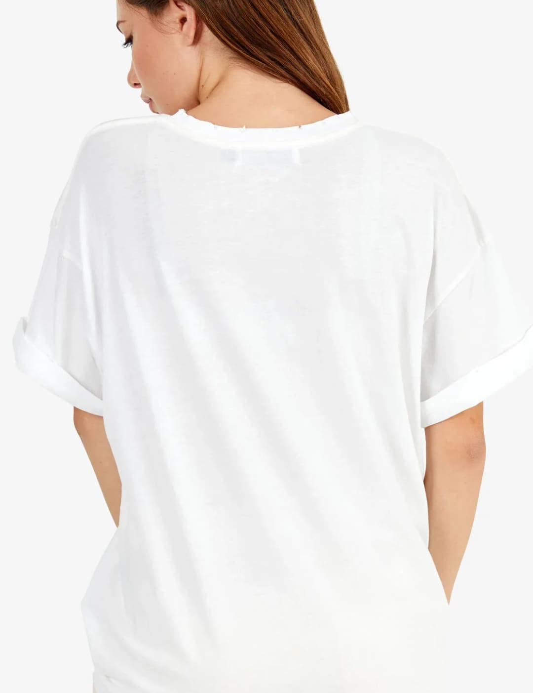 White oversized t-shirt with rolled-up sleeves and a relaxed fit.