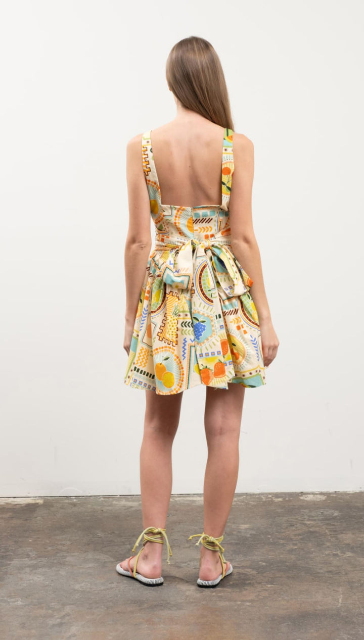 Colorful patterned sundress with tie back.
