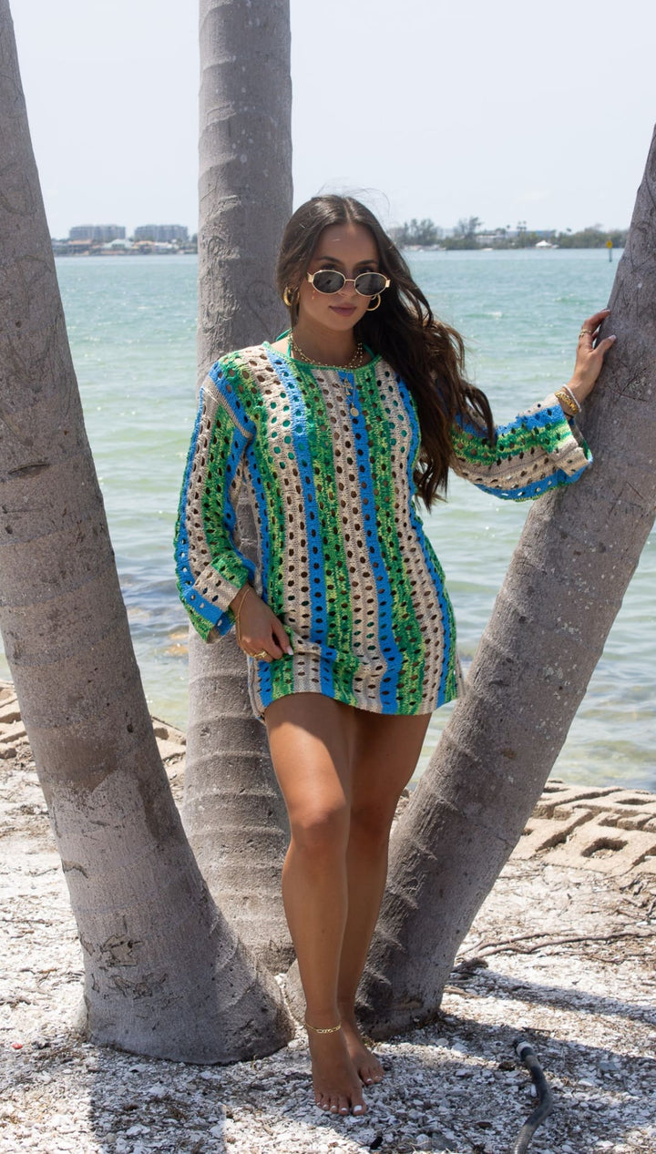 Crocheted mini dress with long sleeves.