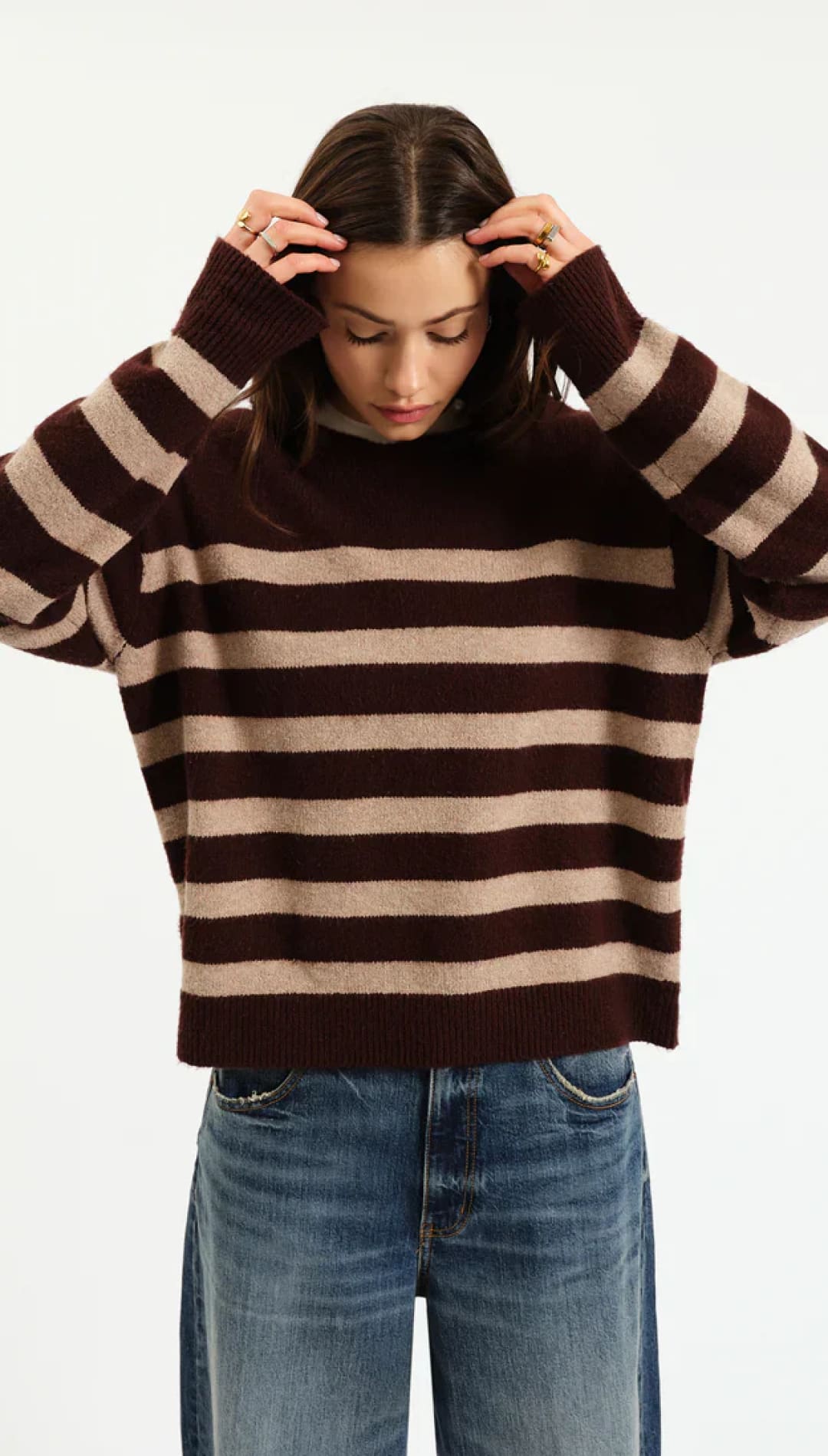 Brown and beige striped turtleneck sweater with ribbed knit texture.