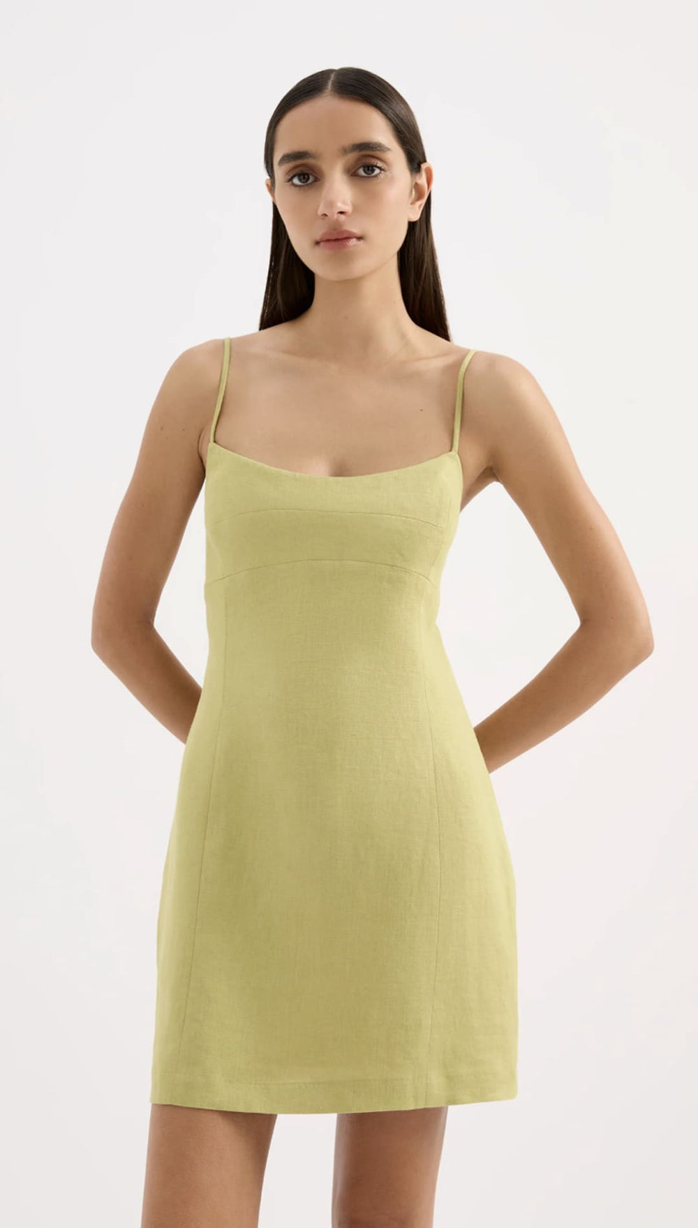 A sleek, pale green sleeveless mini dress with thin spaghetti straps and a flattering fitted silhouette.