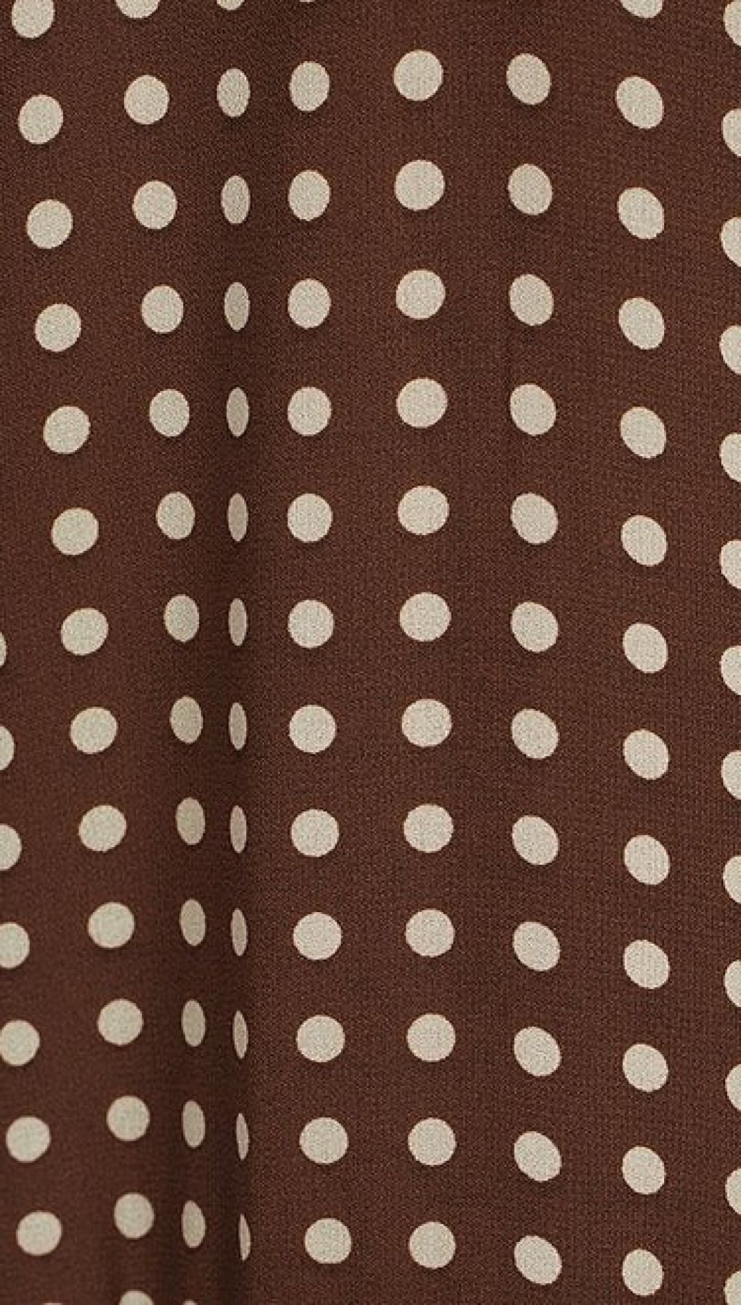 Brown fabric with white polka dots.