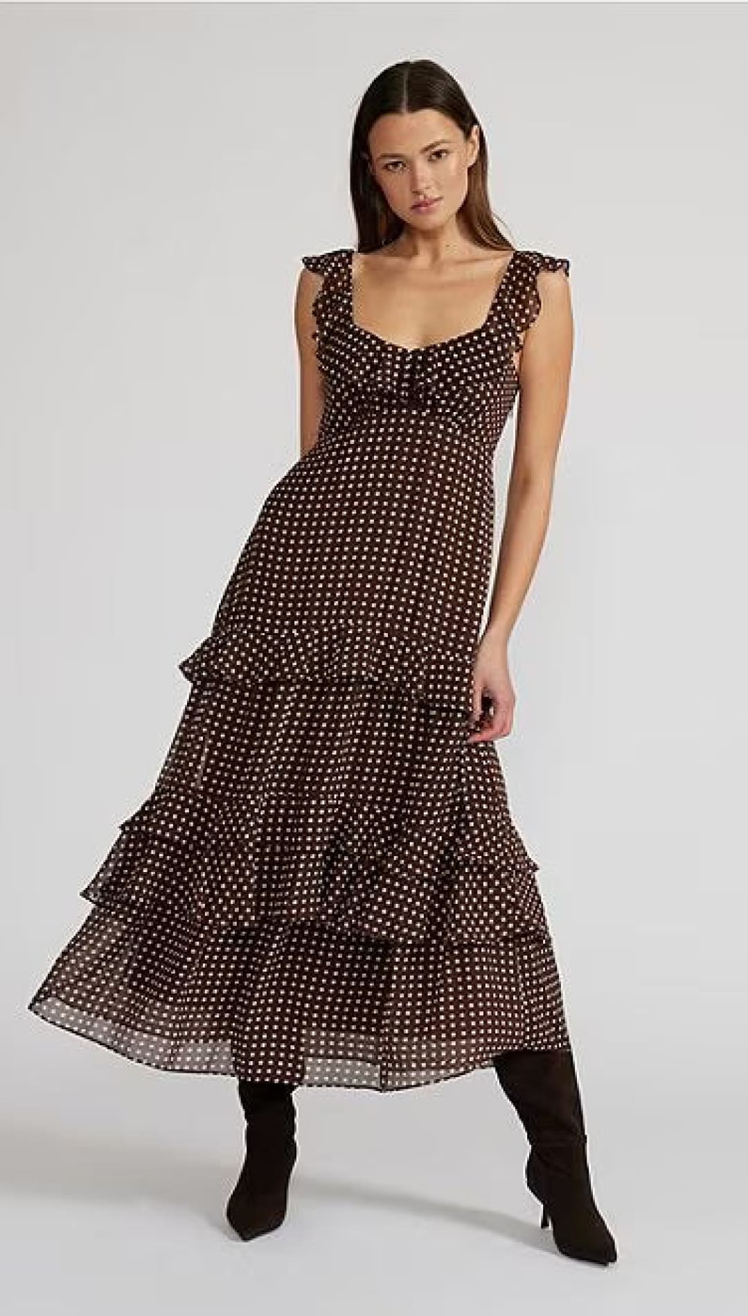 A women’s tiered maxi dress with ruffled straps and a polka dot pattern.
