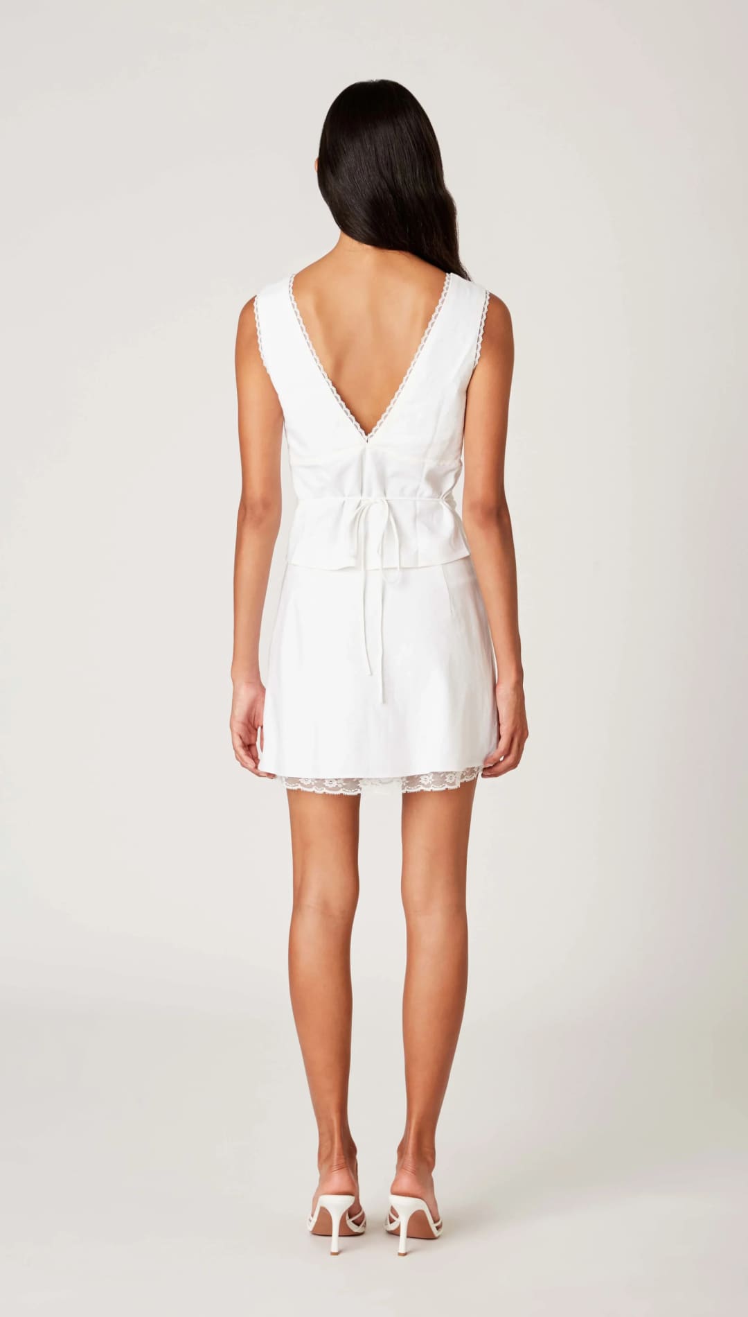 White mini dress with lace trim.