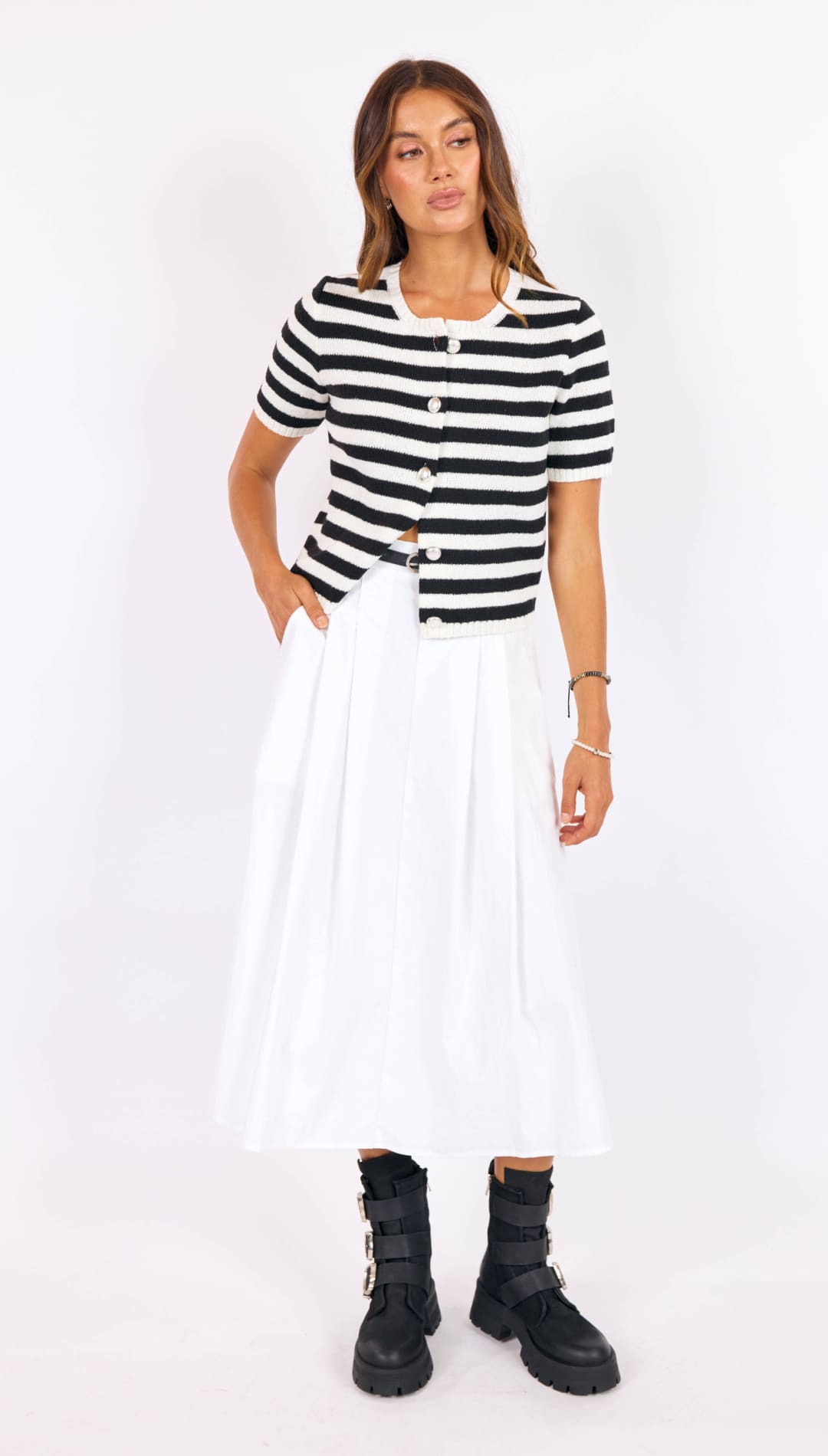 A black and white striped short-sleeved knit cardigan with a button front.