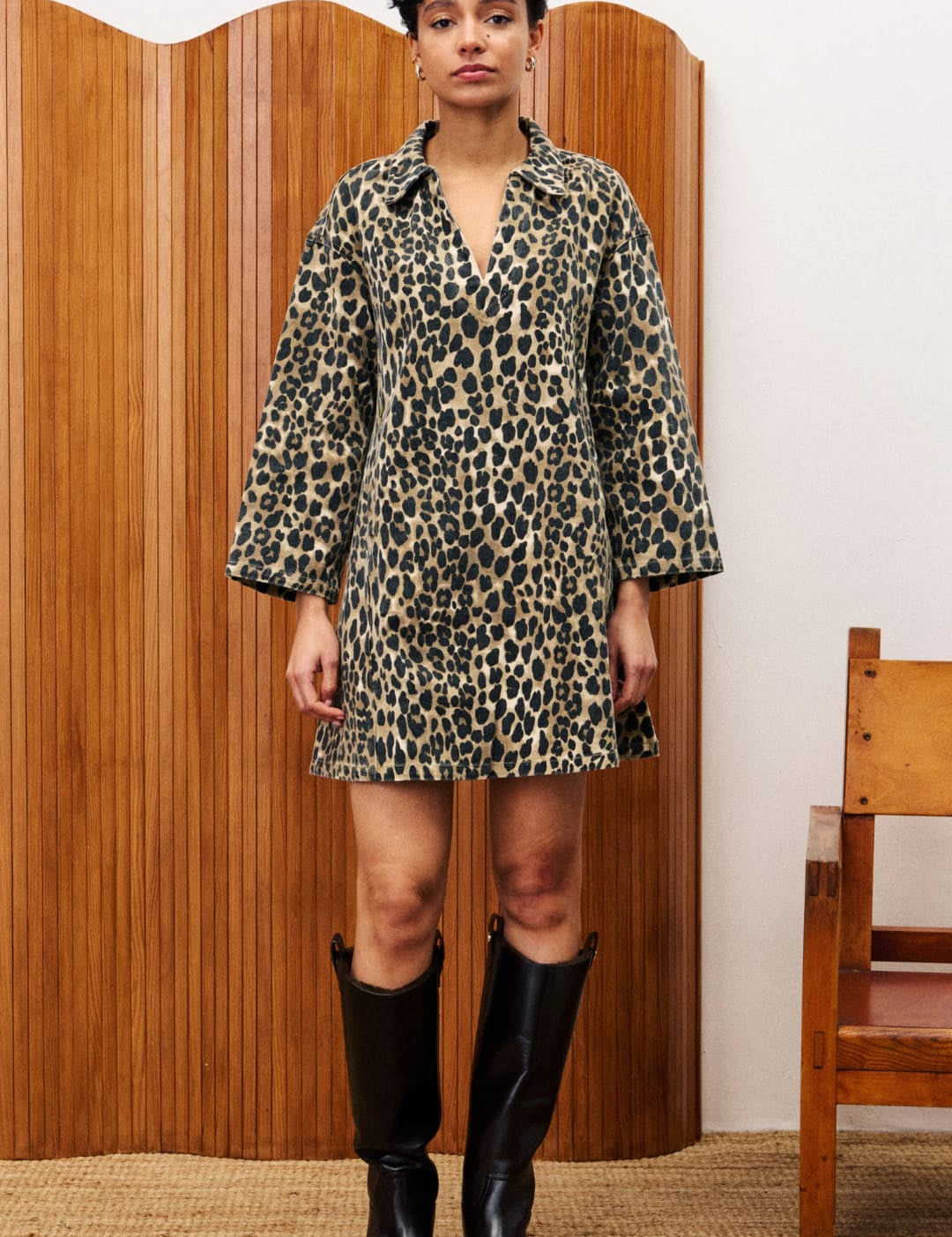 Leopard print mini dress with wide sleeves and a V-neck, paired with black knee-high boots.