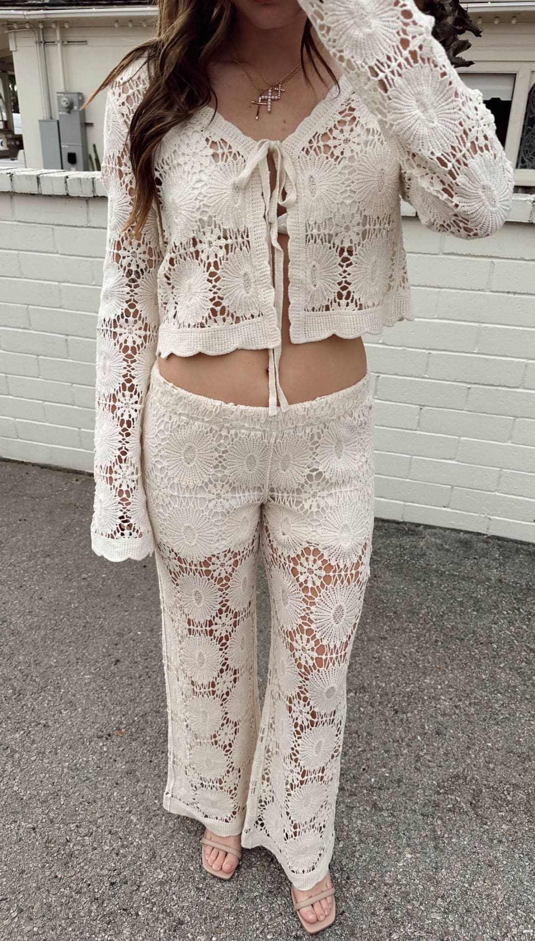 Cream-colored crochet two-piece set with floral lace patterns and a front tie detail.