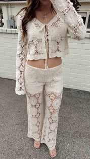 Cream-colored crochet two-piece set with floral lace patterns and a front tie detail.