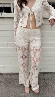 Cream-colored crochet knit two-piece set featuring intricate floral lace patterns and a matching tie-front cardigan.