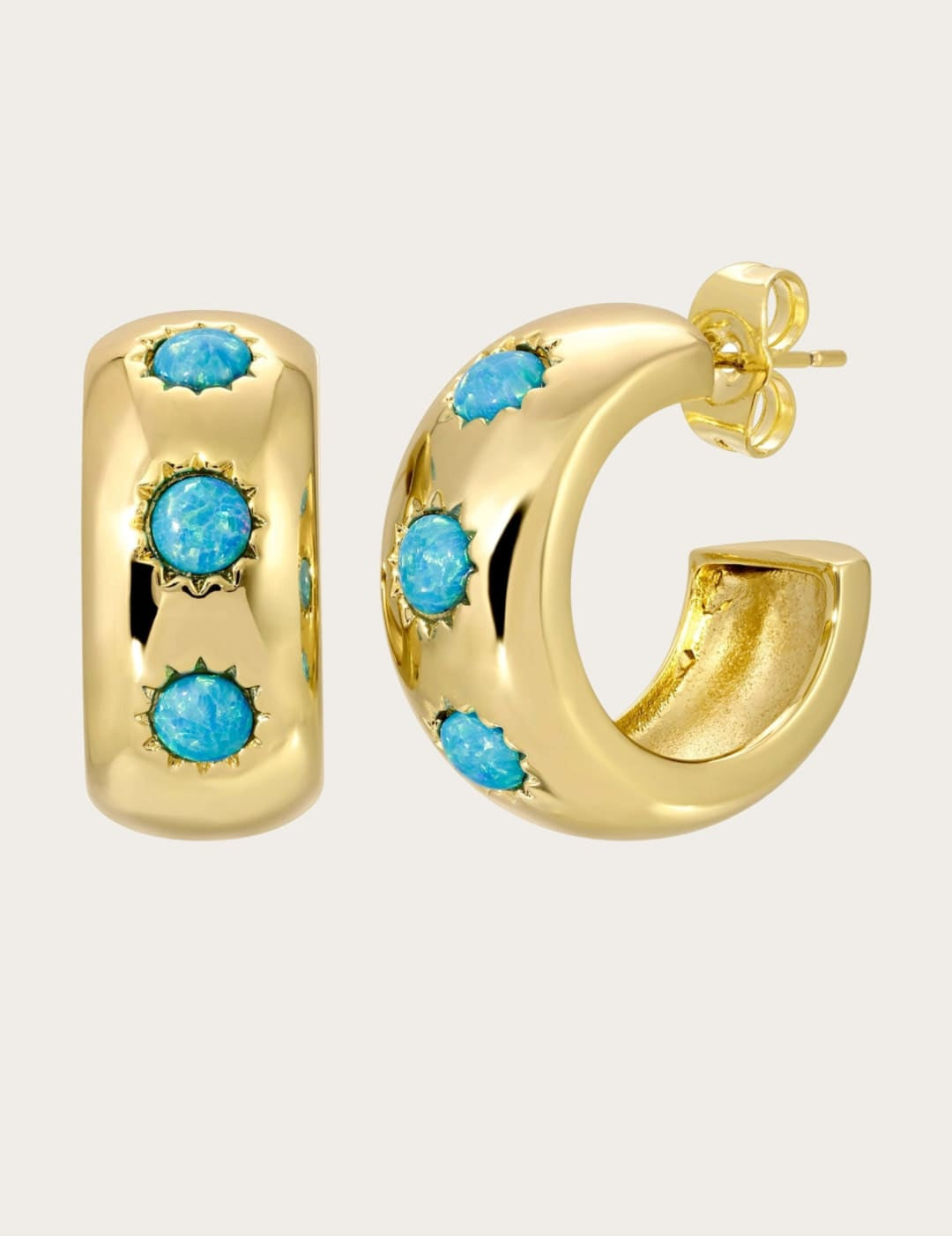 Gold hoop earrings with turquoise stones.