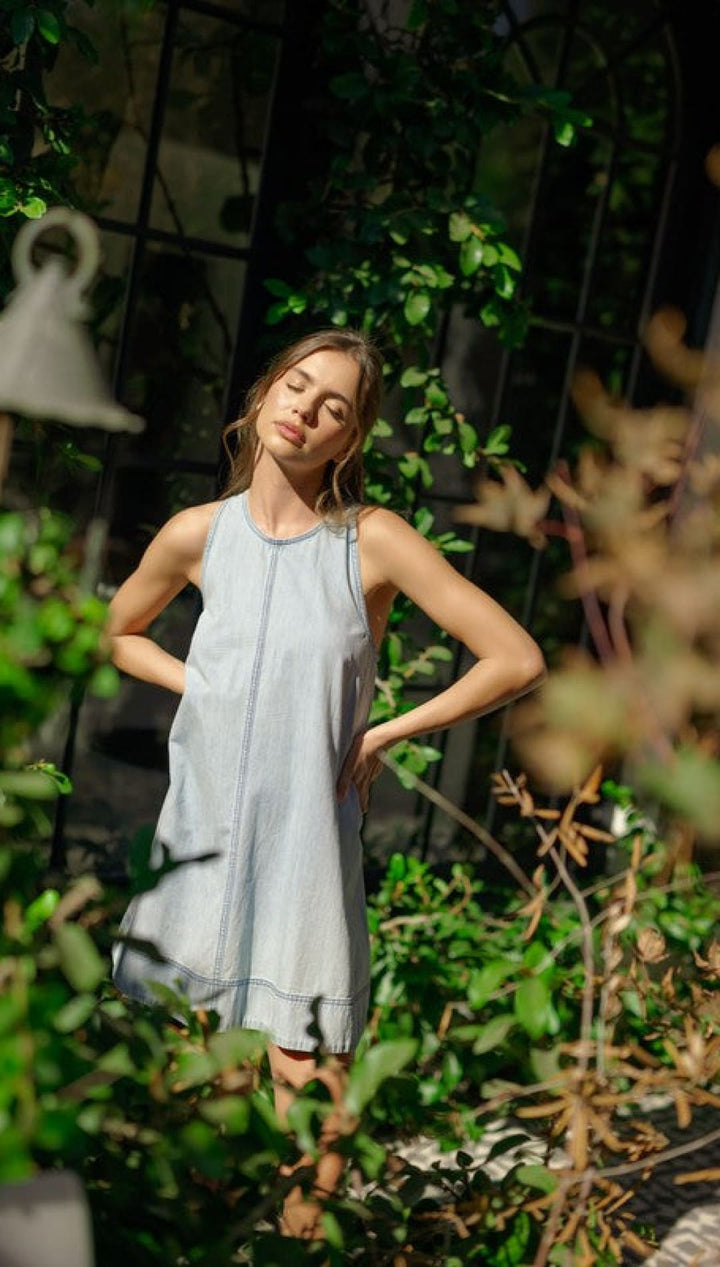 Light blue sleeveless dress.