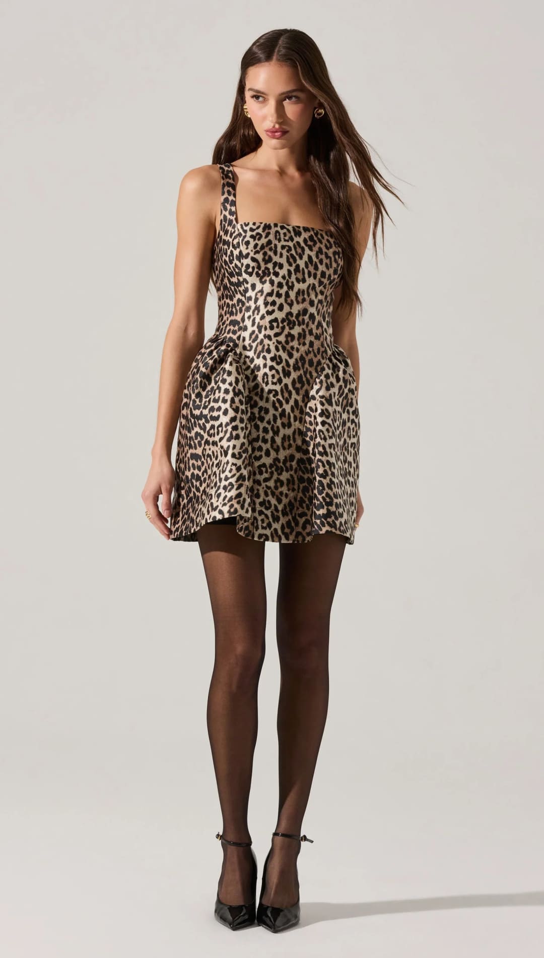 Leopard print mini dress with thick straps and a gathered skirt.