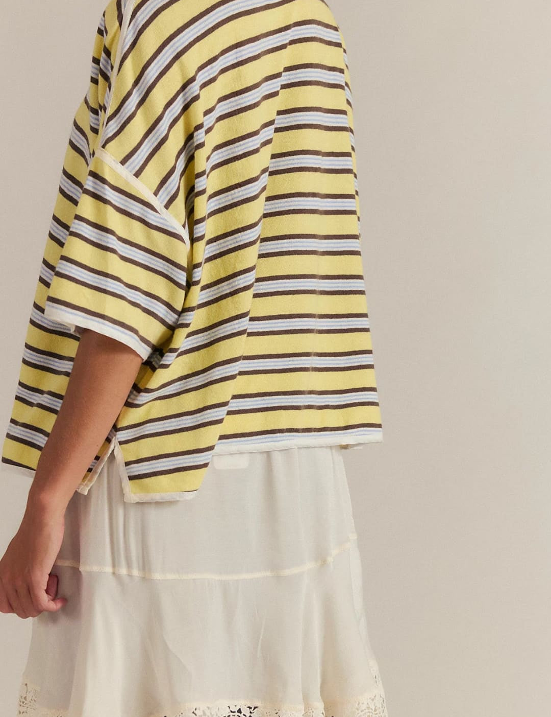 Yellow and white striped oversized t-shirt with floral embroidery on the hem.