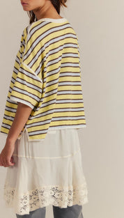 Yellow and white striped oversized t-shirt with floral embroidery on the hem.