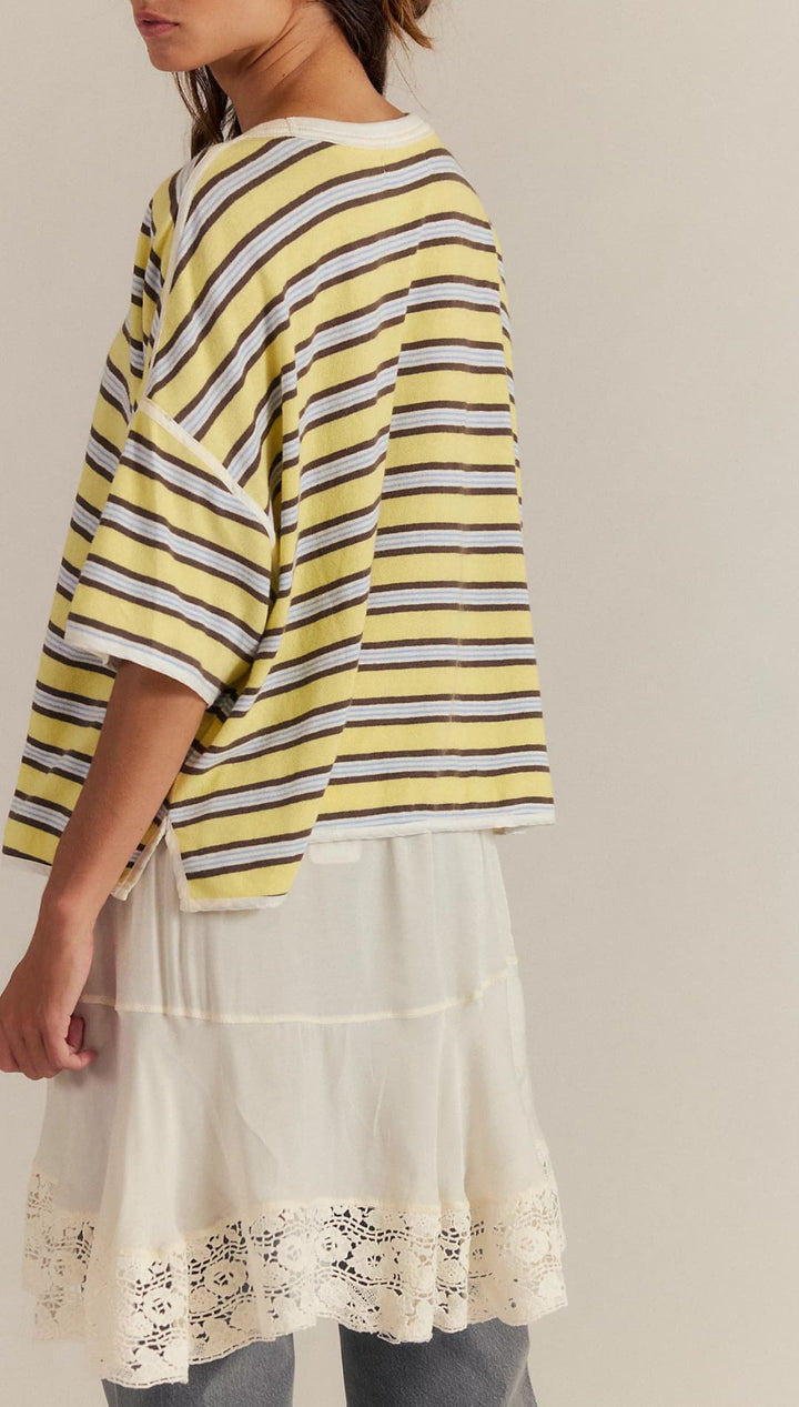 Yellow and white striped oversized t-shirt with floral embroidery on the hem.