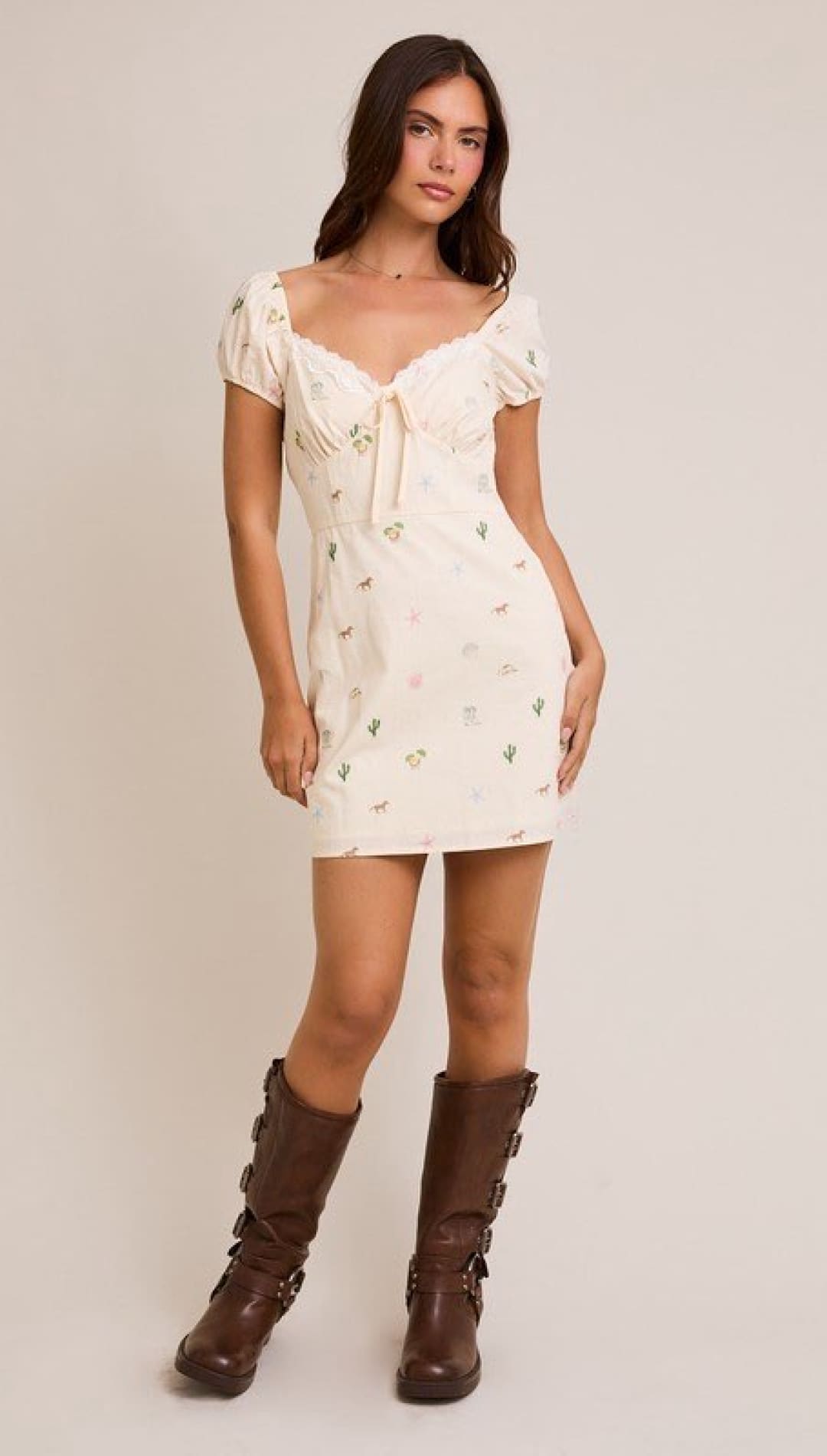 Floral mini dress with brown boots.