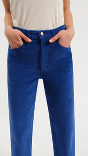 Royal blue corduroy pants with a high waist and button fly design.
