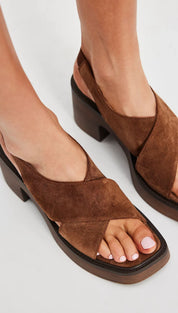 Brown suede cross-strap platform sandals with a chunky heel.