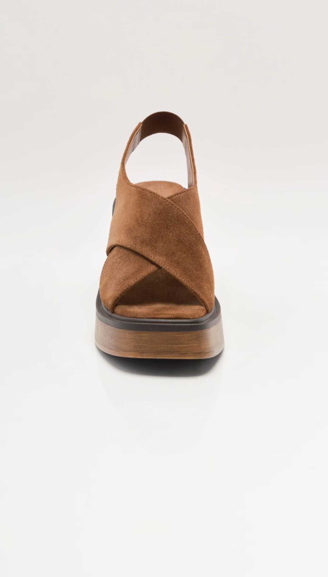 Brown suede cross-strap platform sandal with a chunky wooden sole.