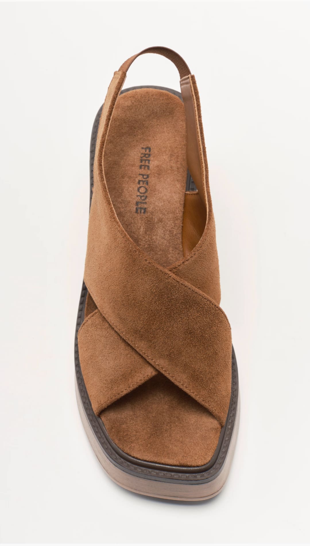 Tan suede cross-strap sandal with a platform sole and adjustable ankle strap.