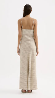 Beige slip dress with delicate gold geometric pattern and thin spaghetti straps.