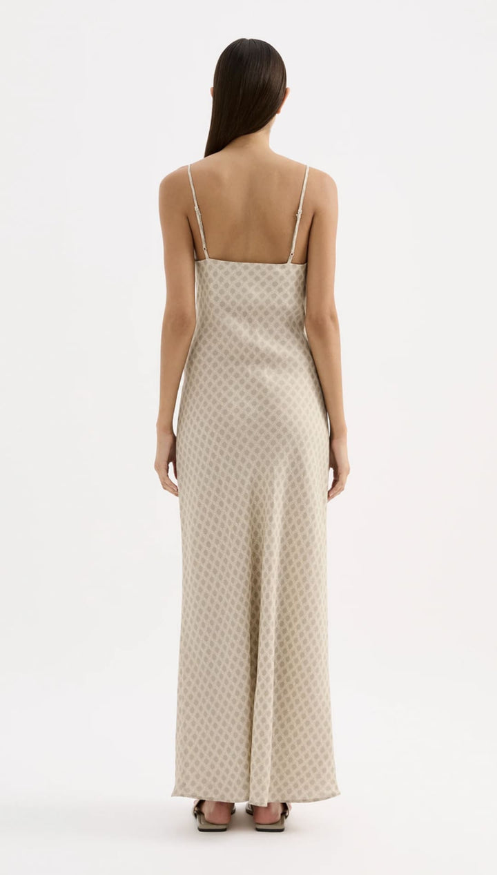 Beige slip dress with delicate gold geometric pattern and thin spaghetti straps.