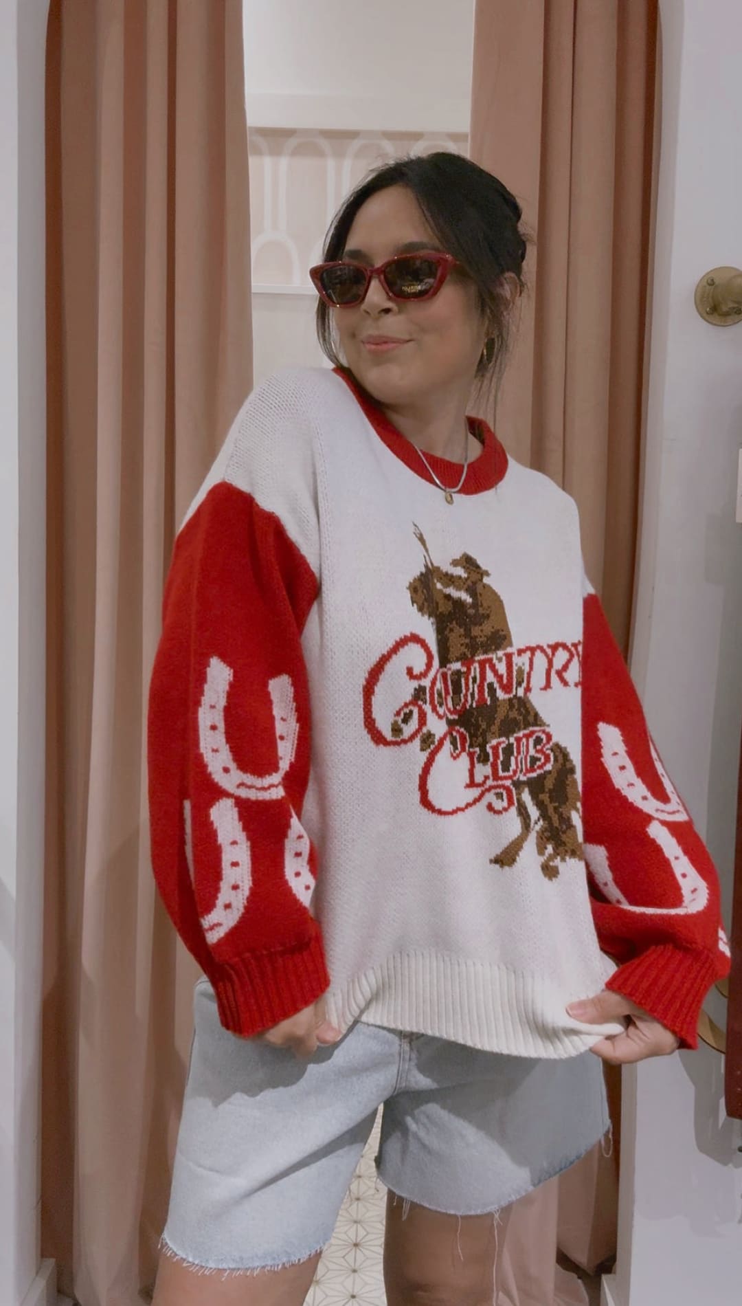 Red and white ’country club’ sweater with horse design, fleece material.