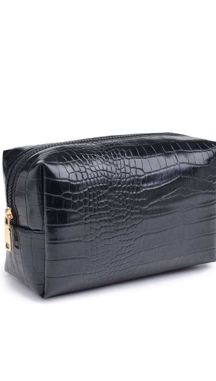 Black crocodile-patterned leather toiletry bag with gold zipper.