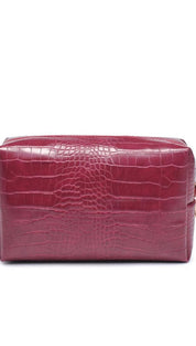 Crocodile-patterned burgundy leather cosmetic bag with gold zipper.