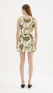 A sleeveless, knee-length dress in cream with an olive green floral pattern.