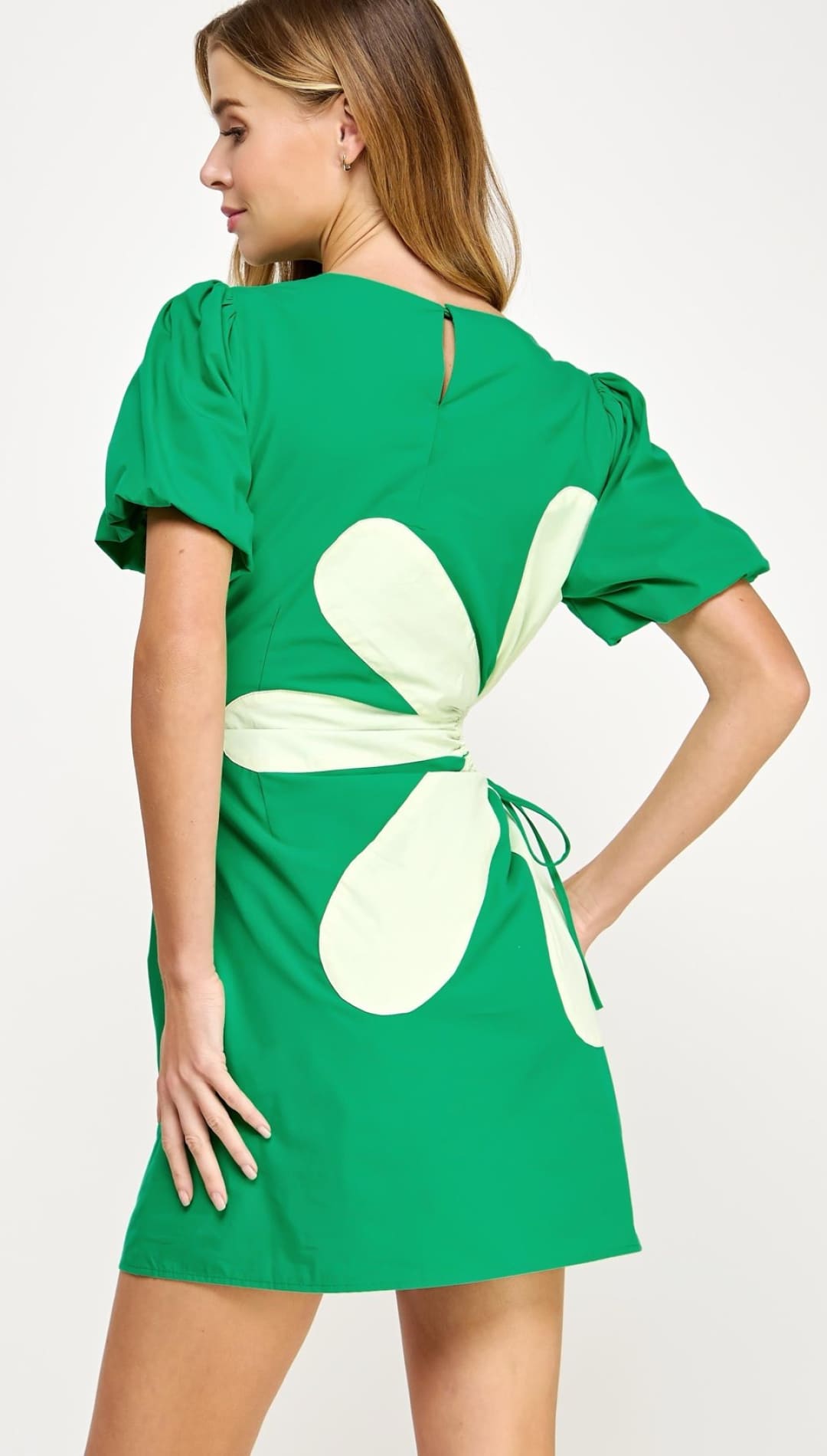 Green dress with floral cutout.