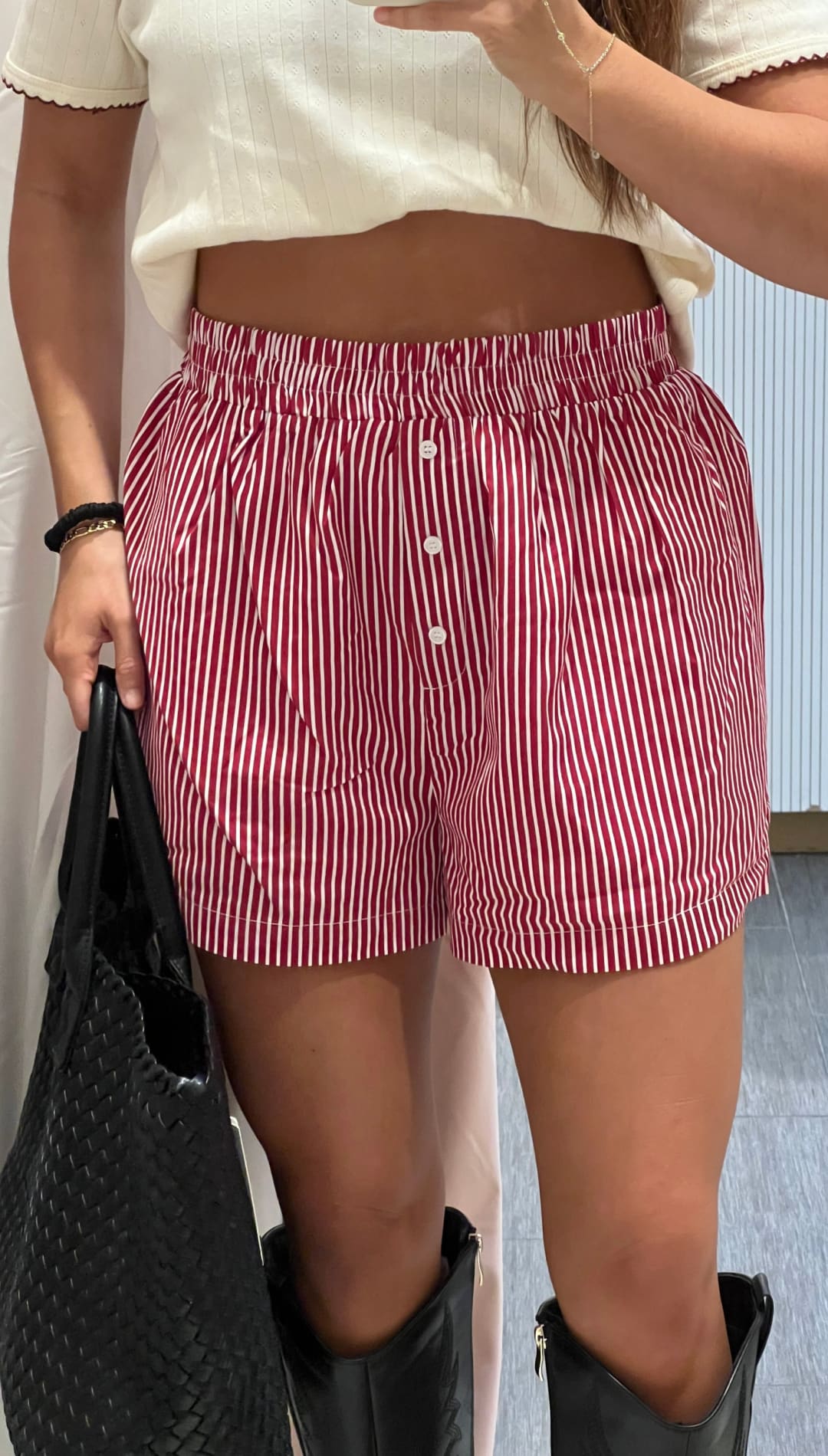 Red and white striped high-waisted shorts with a button fly and elastic waistband.