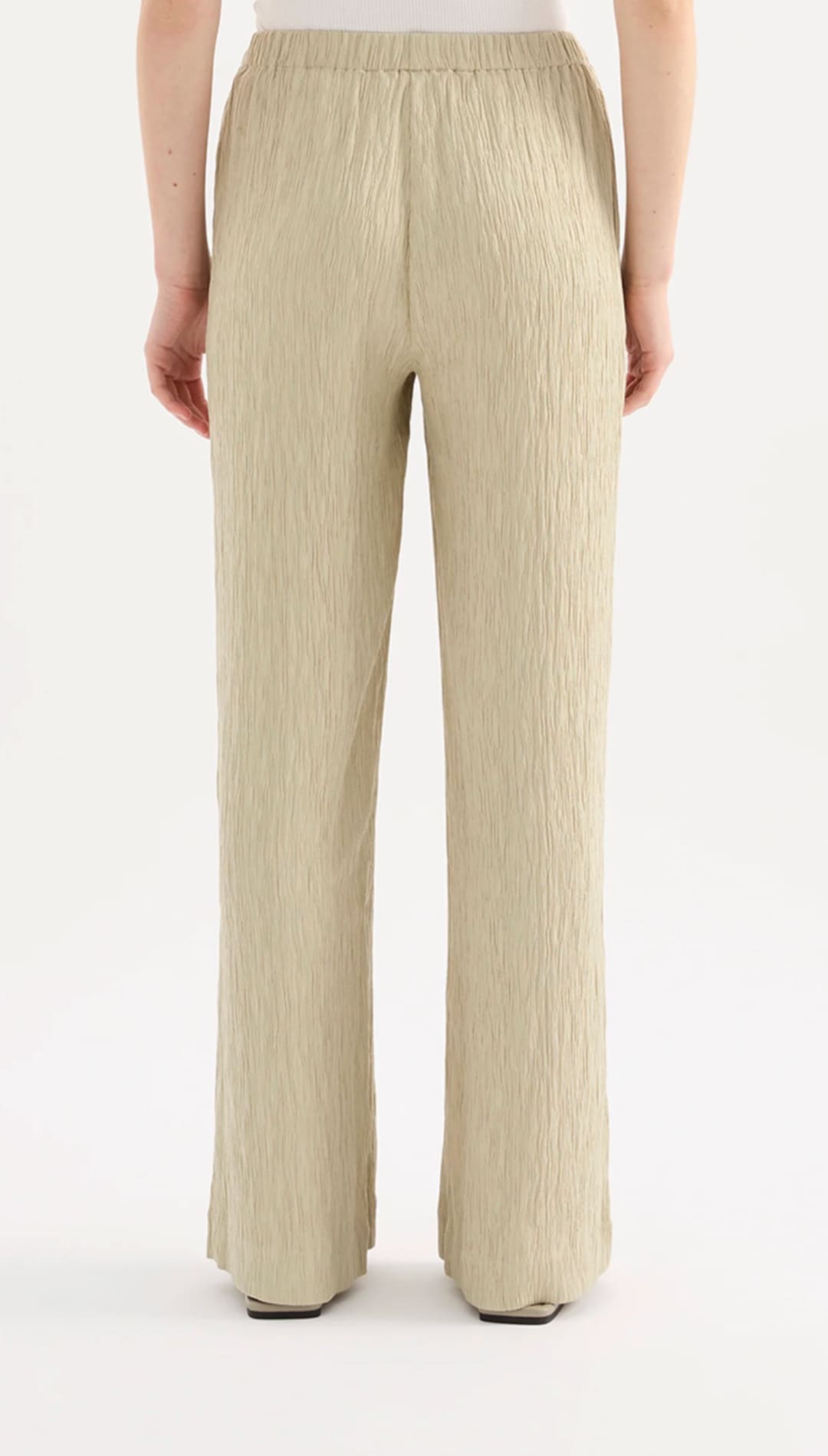 Beige pleated wide-leg trousers with an elastic waistband.