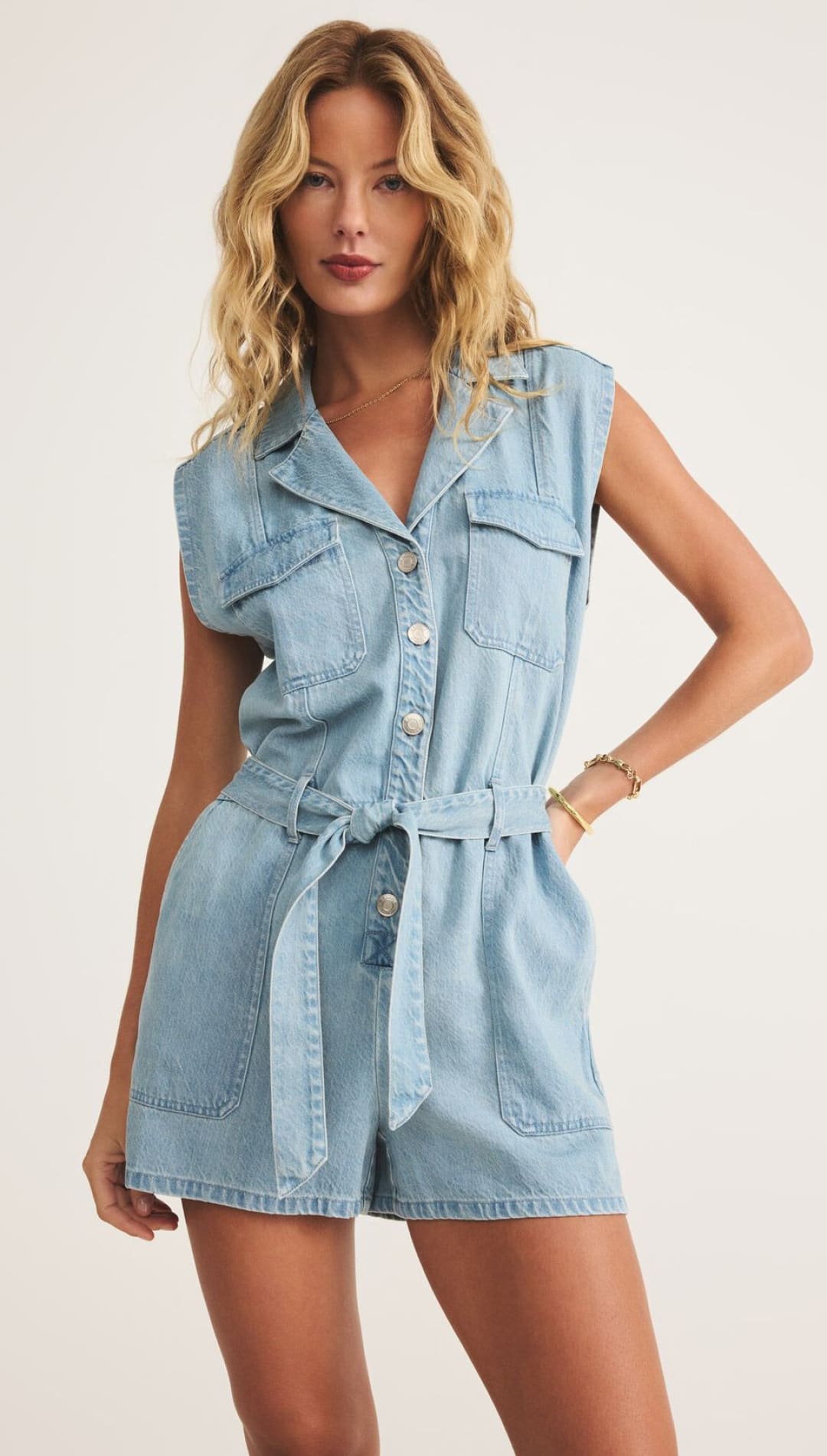 Light blue denim romper with a tie waist.