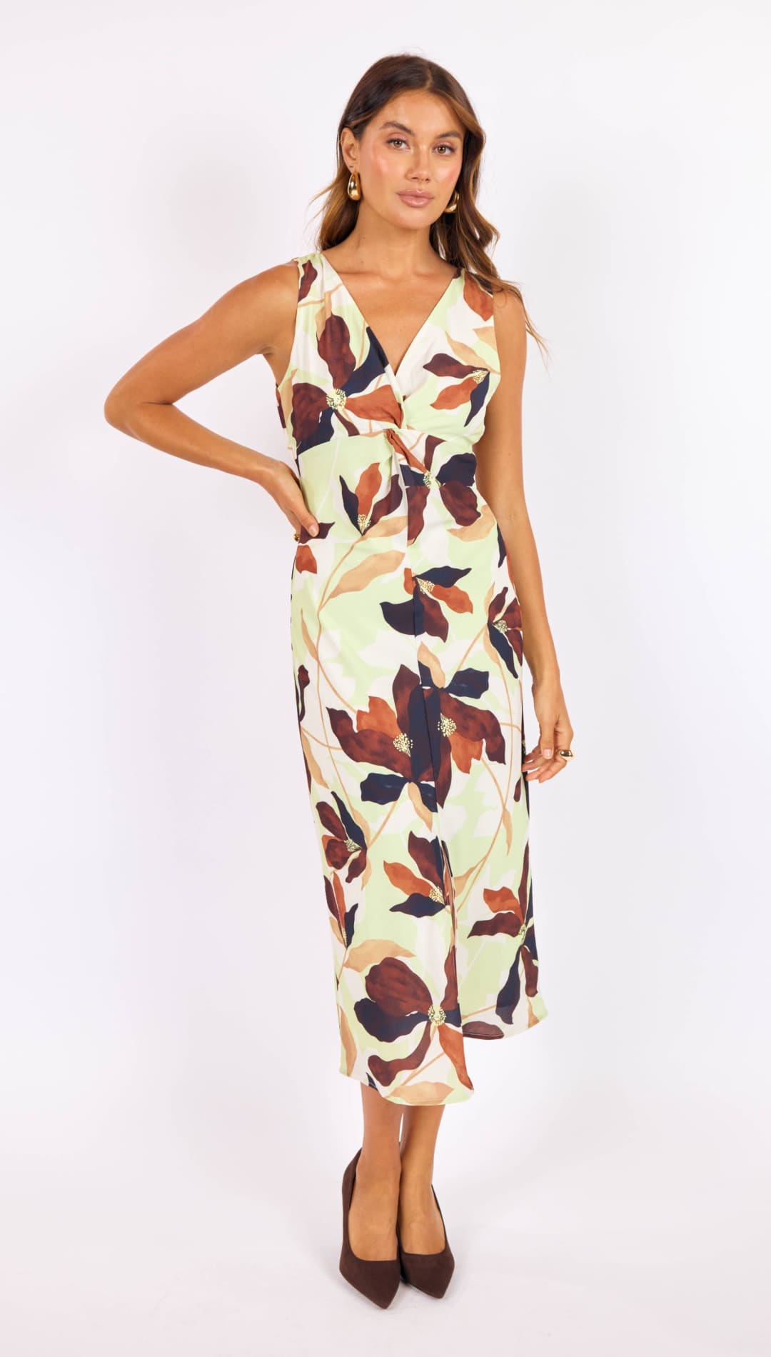 A flowing, sleeveless midi dress in a soft cream base with bold floral patterns in deep burgundy and navy blue.