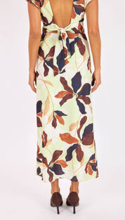 A flowing, back-tie midi dress in a soft mint green fabric adorned with large floral patterns in deep burgundy and burnt orange hues.