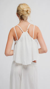 White lace-trimmed camisole top with thin spaghetti straps
