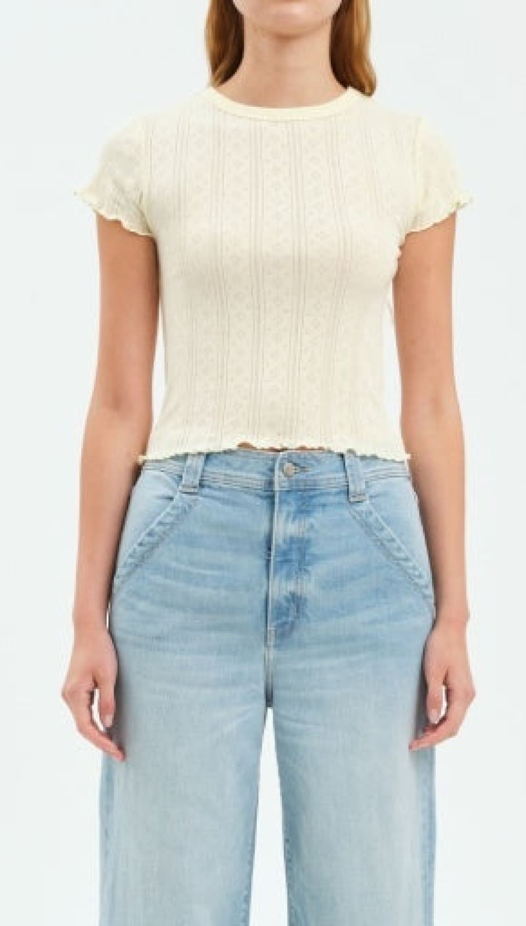 Woman’s ribbed knit top with wide-leg jeans.
