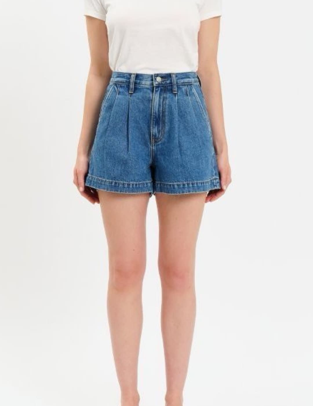 High-waisted denim shorts in a classic medium blue wash with pleated front and rolled hem.