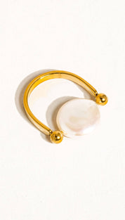 Gold-toned ring with a smooth, round white pearl centered on an open band design.